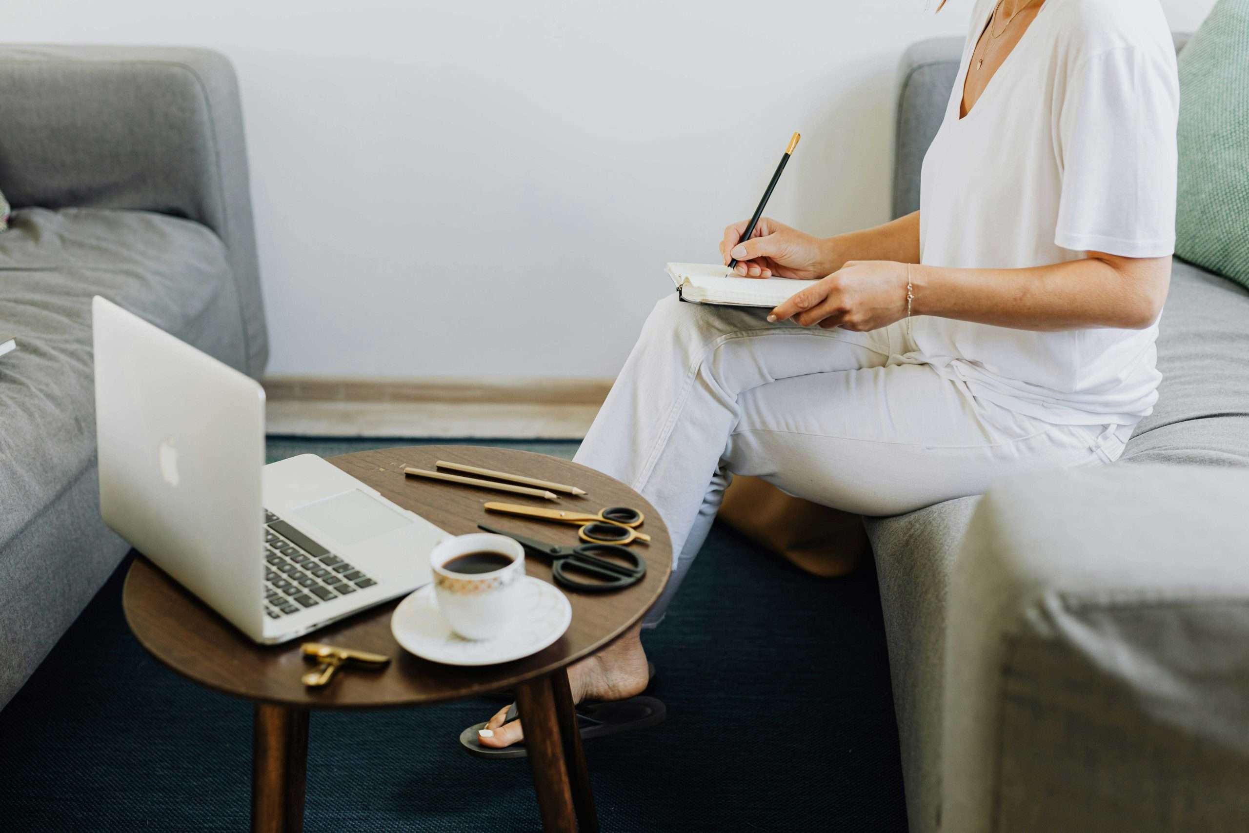 How to Create a Blog Strategy That Generates Leads for Your Small Business in 2026 | Westco Web Design Small business owner planning blog content strategy with notebook and laptop.