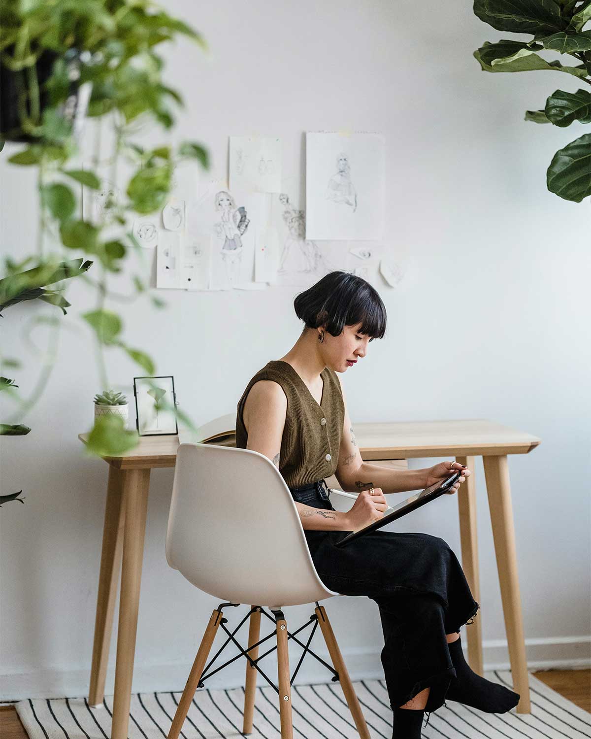 Creative professional sketching on a digital tablet, demonstrating the hands-on customization and strategy offered by a web designer.