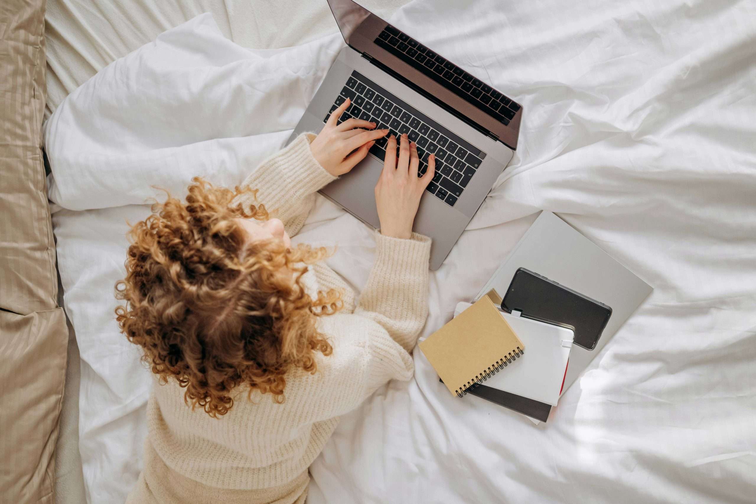 Freelancer working from home on laptop creating content strategy for her blog.