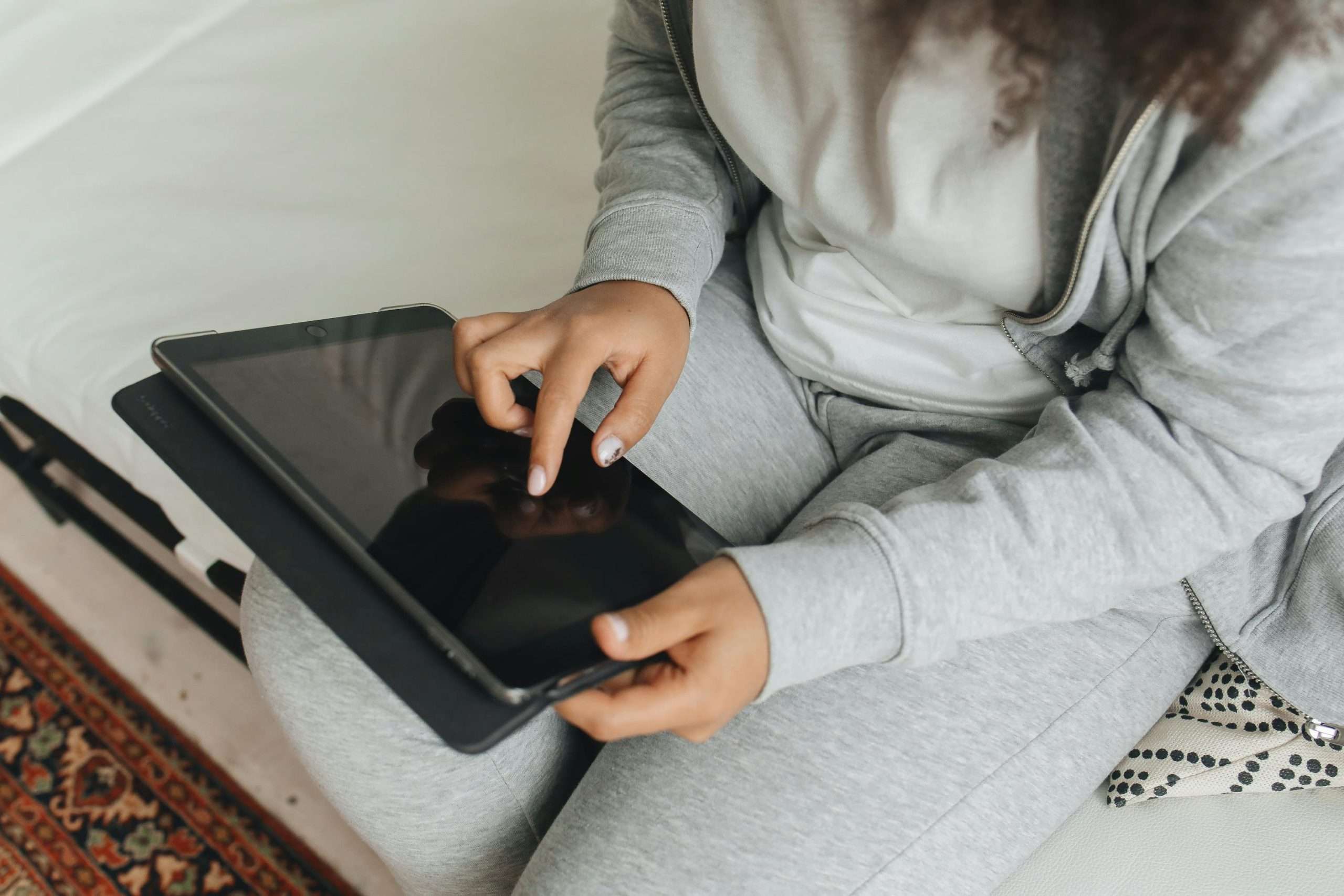 Website Strategy Session | Westco Web Design Person in cozy sweater using iPad and stylus — personalized website review and actionable recommendations.