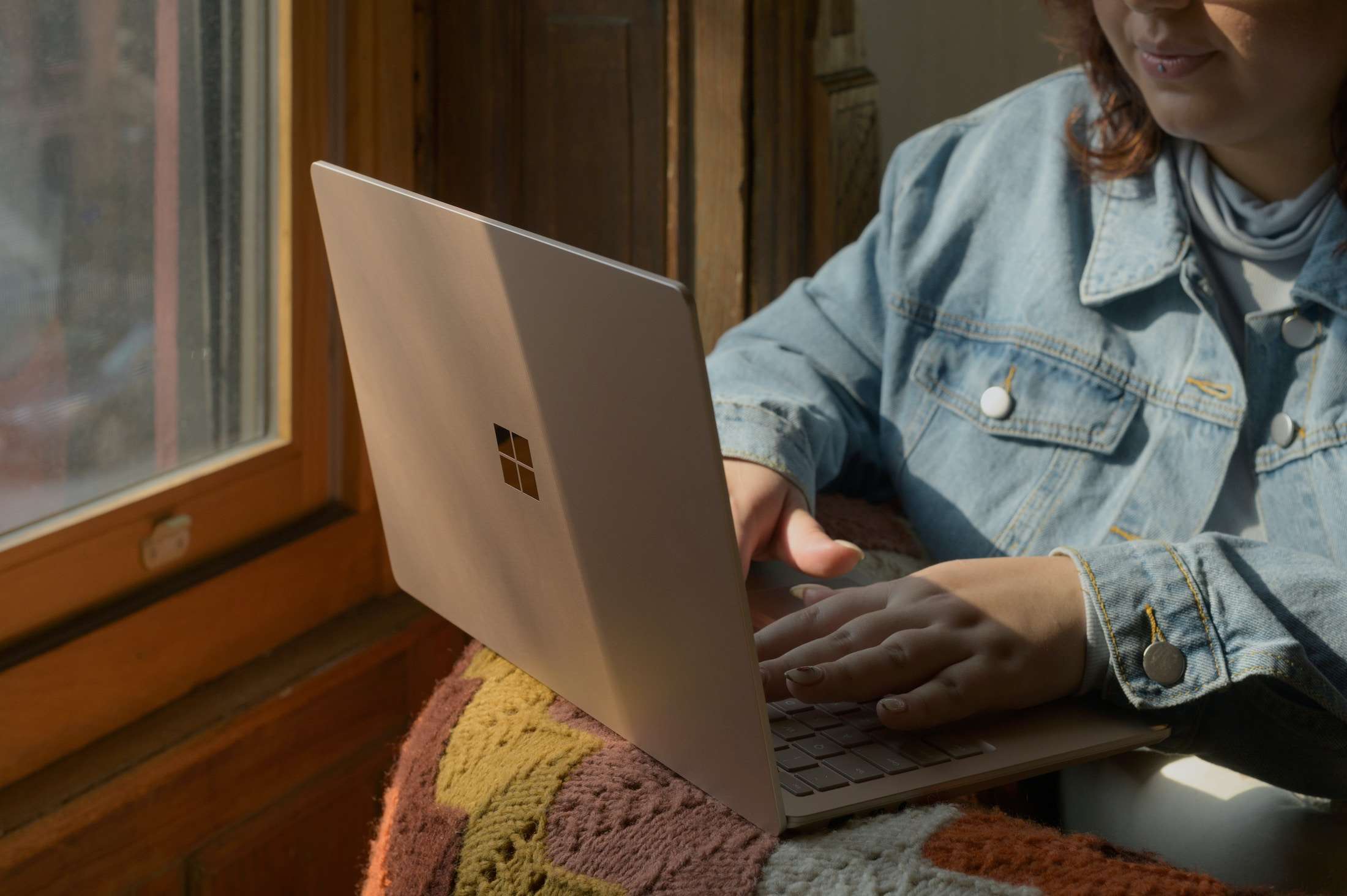 4 SEO Strategies That Still Matter in 2025 (Even In The Age of AI) | Westco Web Design Laptop and notebook on a wooden desk beside a window, ready for an SEO content planning session.